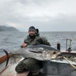 fishing tourism fisherman with big fish profile